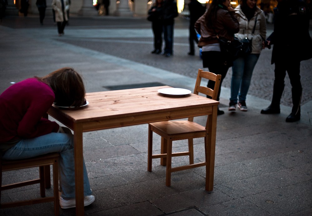 Girl figure fallen into a cake on a table